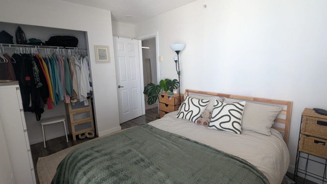 Bedroom featuring a closet, wood finished floors, and baseboards | Image 15