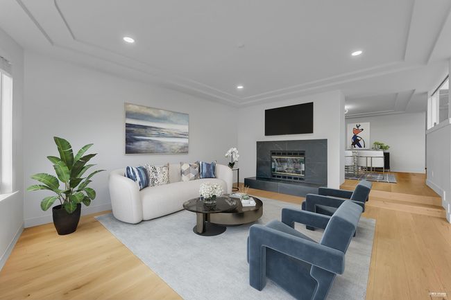 Living room with wood finished floors, baseboards, a fireplace, and recessed lighting | Image 9