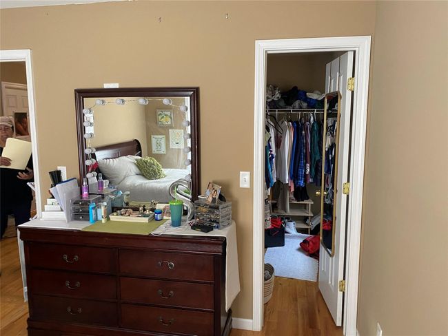 Bedroom featuring a spacious closet, wood finished floors, and a closet | Image 15