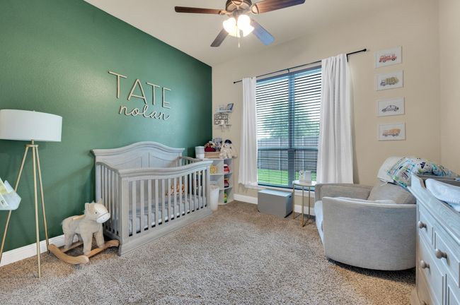 Carpeted bedroom with a crib, baseboards, and ceiling fan | Image 26