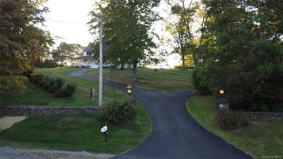 View of home's community featuring a lawn | Image 2