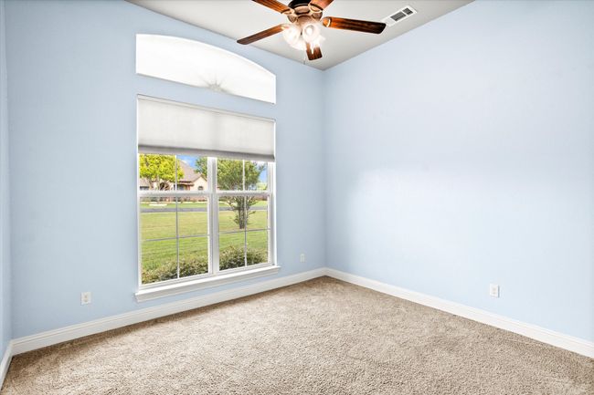 Unfurnished room with carpet, baseboards, and a ceiling fan | Image 23