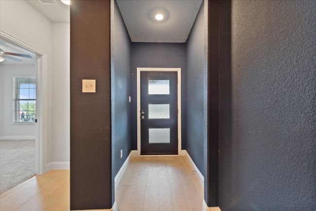 Doorway featuring ceiling fan and light hardwood / wood-style flooring | Image 5