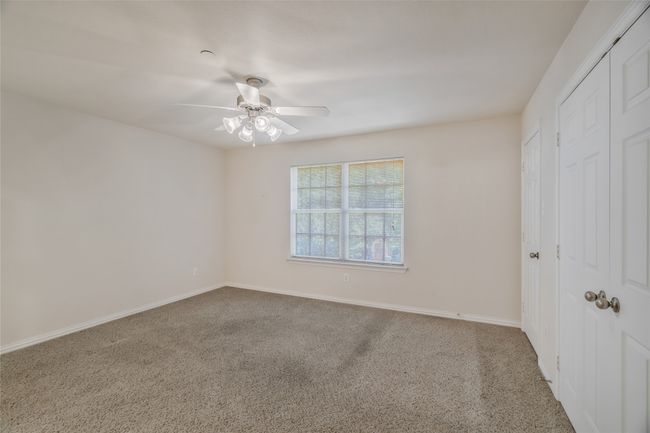 Unfurnished bedroom featuring carpet floors, a closet, baseboards, and ceiling fan | Image 17