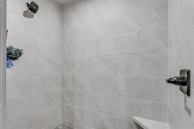 Room details featuring tiled shower | Image 18
