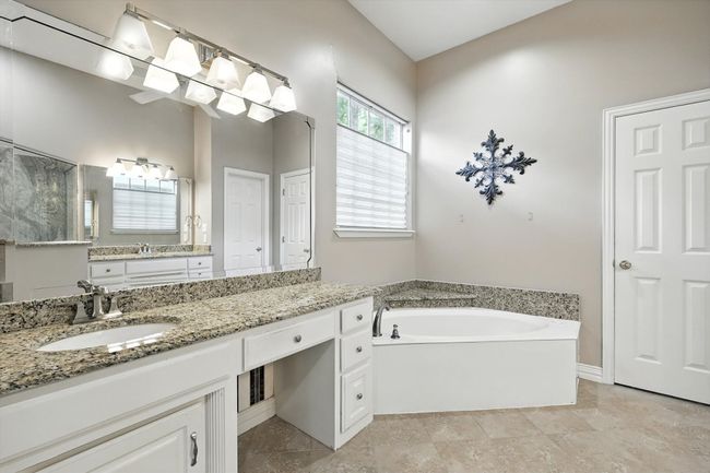 Full bathroom with a shower stall, vanity, and tile patterned flooring | Image 14