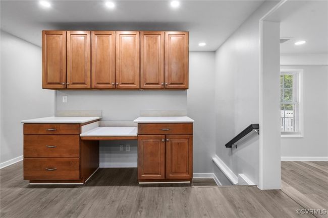 Unfurnished office with built in desk, recessed lighting, wood finished floors, and baseboards | Image 13