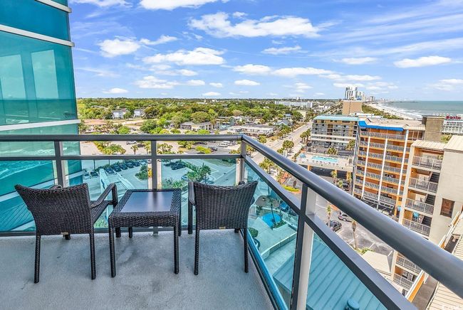Balcony featuring a city view and a water view | Image 30