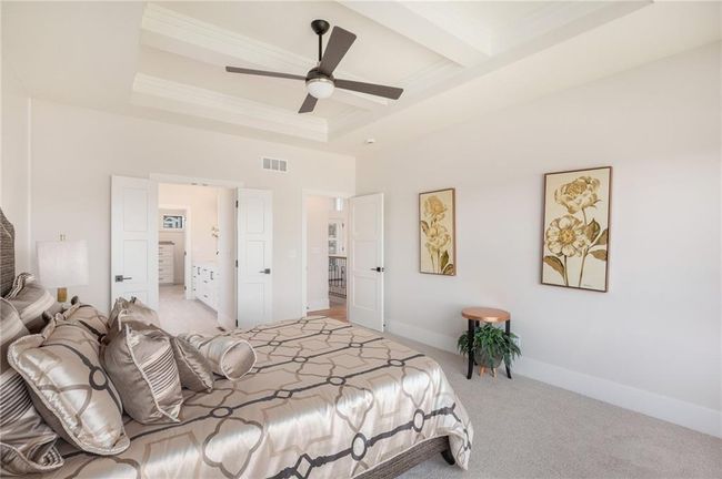 Carpeted bedroom featuring crown molding, ceiling fan, and a tray ceiling | Image 17