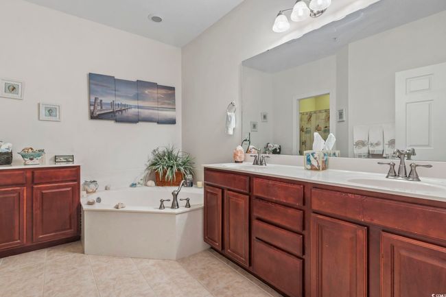 Full bath with double vanity, a bath, tile patterned floors, and an enclosed shower | Image 11