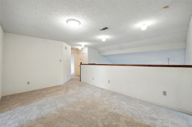 Spare room featuring light carpet, a smoke detector, and a textured ceiling | Image 24
