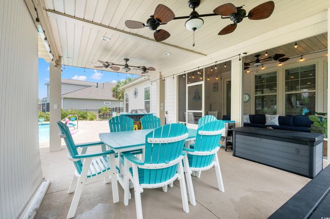 View of patio / terrace with ceiling fan, an outdoor hangout area, and outdoor dining area | Image 31