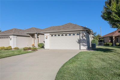 View of front of house with a garage, central AC, and a front yard | Image 2