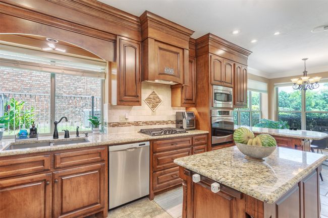 Kitchen with stainless steel appliances, and a center island | Image 11