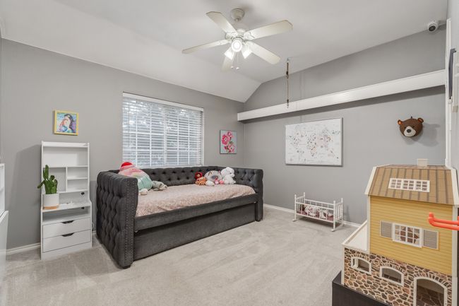 Bedroom featuring carpet floors, vaulted ceiling, baseboards, and ceiling fan | Image 12