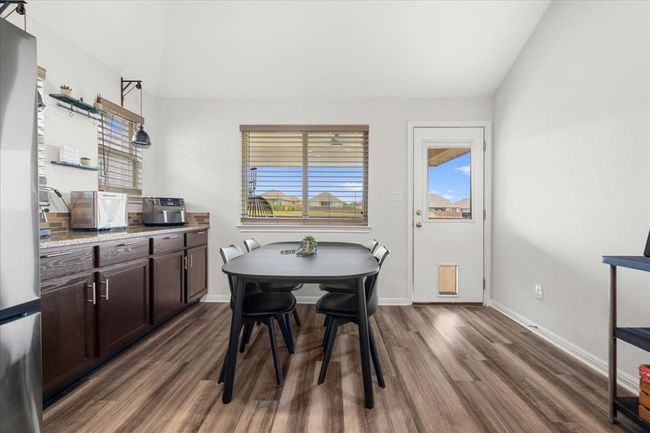 Dining room featuring wood finished floors, vaulted ceiling, and baseboards | Image 30