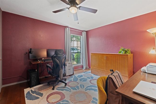 Office space featuring baseboards, a textured wall, a ceiling fan, and wood finished floors | Image 26