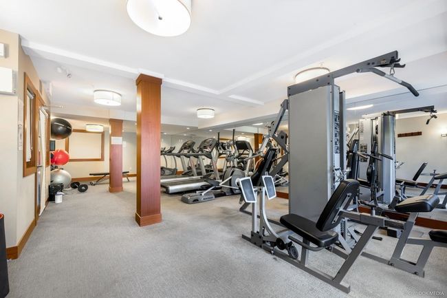 Workout area featuring ornate columns and baseboards | Image 24
