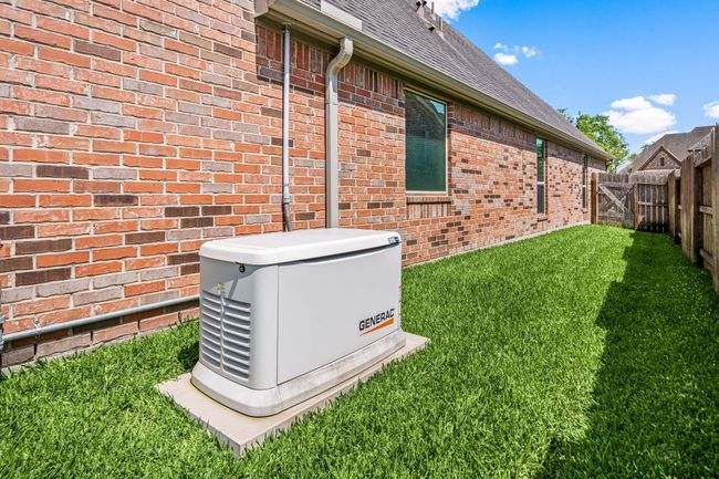 This home comes equipped with a full home generac generator that comes with a warranty. | Image 32