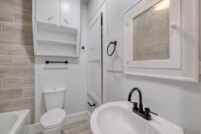 Full bathroom featuring a sink and toilet | Image 14
