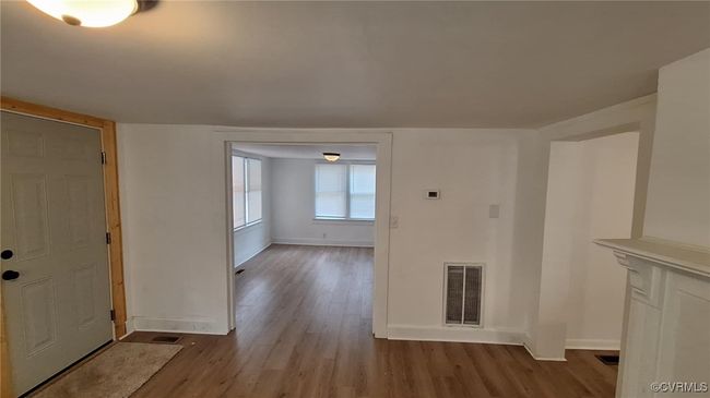 Foyer entrance with visible vents, baseboards, and wood finished floors | Image 9