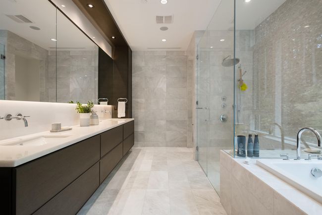Bathroom featuring a garden tub, double vanity, a stall shower, tile walls, and recessed lighting | Image 23