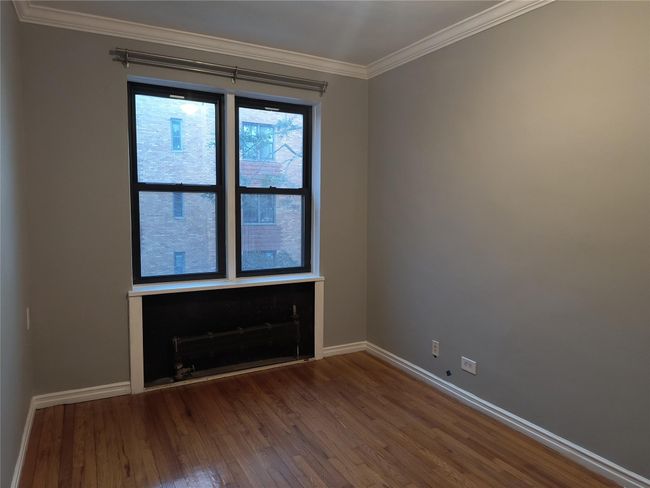 Spare room with wood finished floors, baseboards, and ornamental molding | Image 21