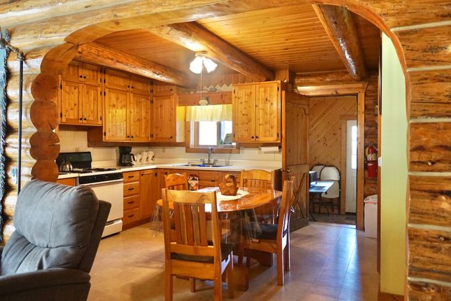 Kitchen featuring light countertops, wood ceiling, a sink, light floors, and white range with gas stovetop | Image 25