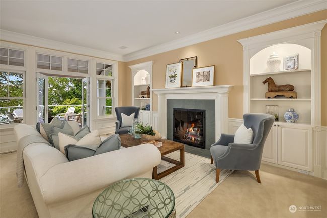 Fabulous entertaining size living room with gas fireplace, built-ins and French doors that open to the veranda that extends the width of the home. | Image 5