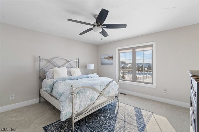 Junior suite featuring light carpet and ceiling fan with attached private bath | Image 22