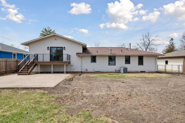 Back of home offers a new maintenance free deck, large concrete area for a patio and a fully fenced yard. Newly seeded and will come in great. | Image 23