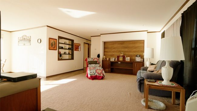 Sitting room with baseboards, carpet, and ornamental molding | Image 12
