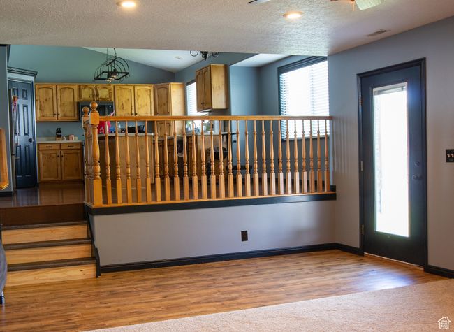 Carpet & wood finished floors, a textured ceiling, recessed lighting, and baseboards, and outdoor entry | Image 11