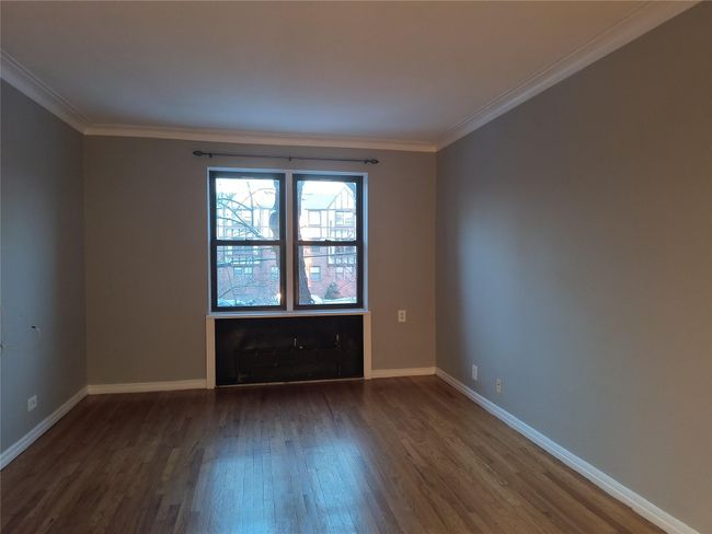 Unfurnished room with dark wood-type flooring, crown molding, and baseboards | Image 15