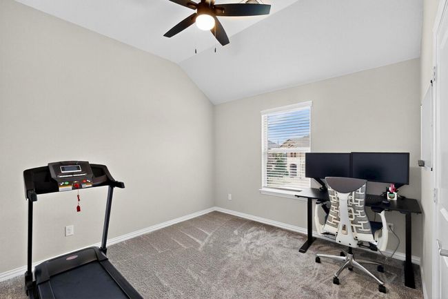 Carpeted home office featuring vaulted ceiling and ceiling fan | Image 28
