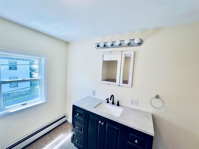 Bathroom with a baseboard heating unit and vanity | Image 17