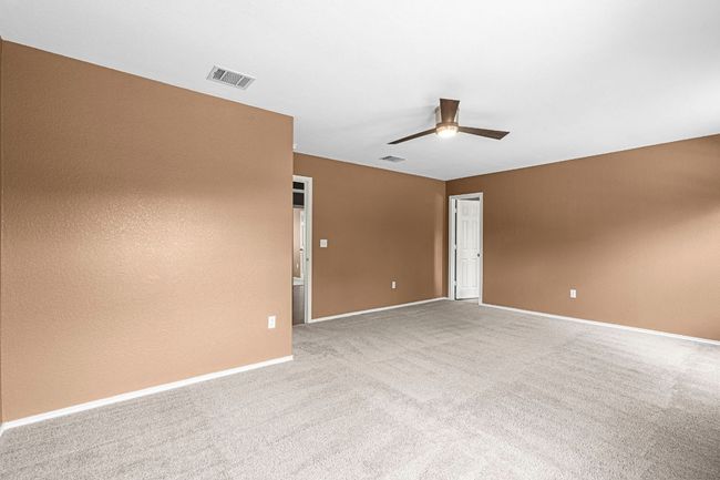 Carpeted empty room with ceiling fan and baseboards | Image 21