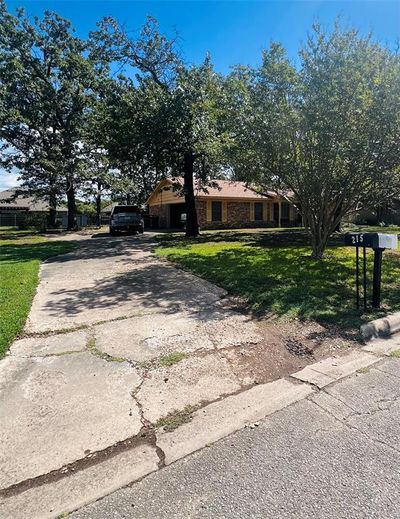 Ranch-style house with a front lawn | Image 1