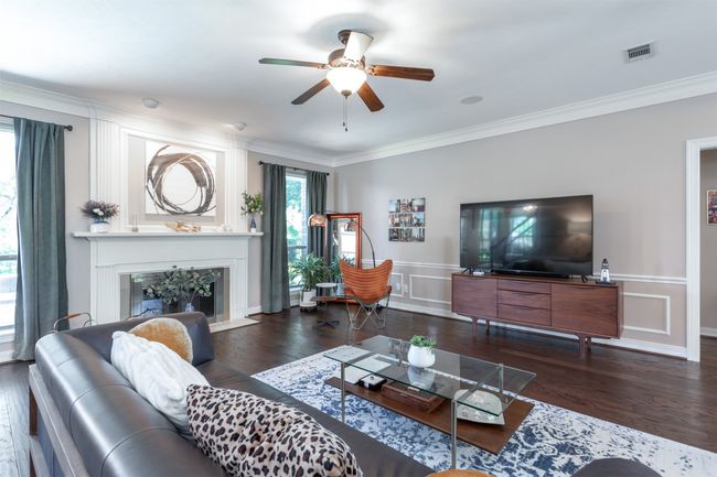 Living area featuring a fireplace with flush hearth | Image 9