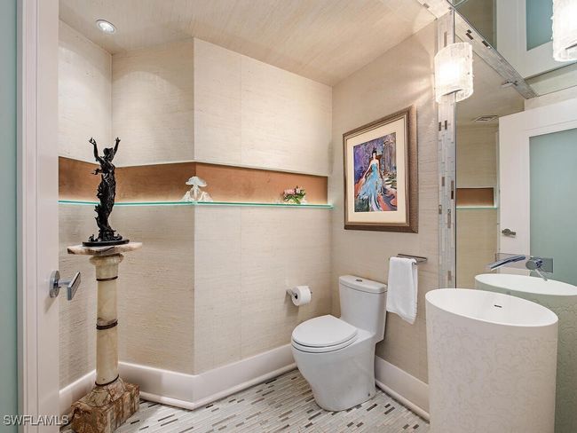 Custom Guest Bathroom featuring Tile Glass flooring with Glass and mirrored design elements throughout. Additional storage cabinet space. | Image 15