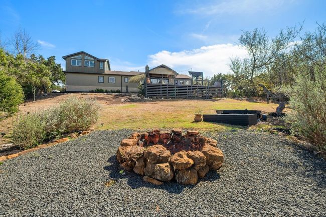 View of yard with a fire pit and a wooden deck | Image 29