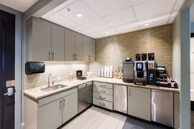 Kitchen featuring tasteful backsplash, dishwasher, gray cabinetry, and a sink | Image 33