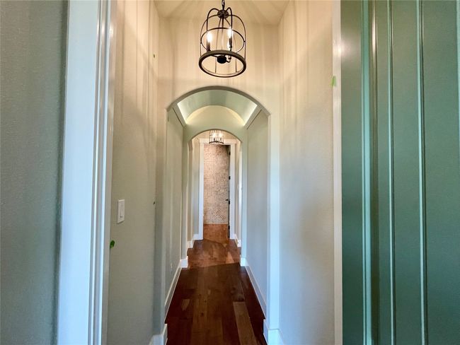 Master hallway with two chandeliers and barrel ceiling. | Image 18