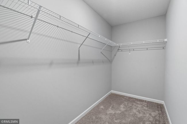 (Photo of previously finished home) The owner's suite includes a generously sized walk-in closet that offers ample storage space. | Image 12