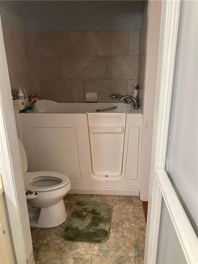 Bathroom with toilet and a bathtub | Image 7