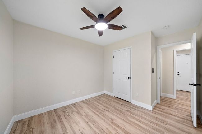 Unfurnished bedroom featuring light wood-style flooring and ceiling fan | Image 22