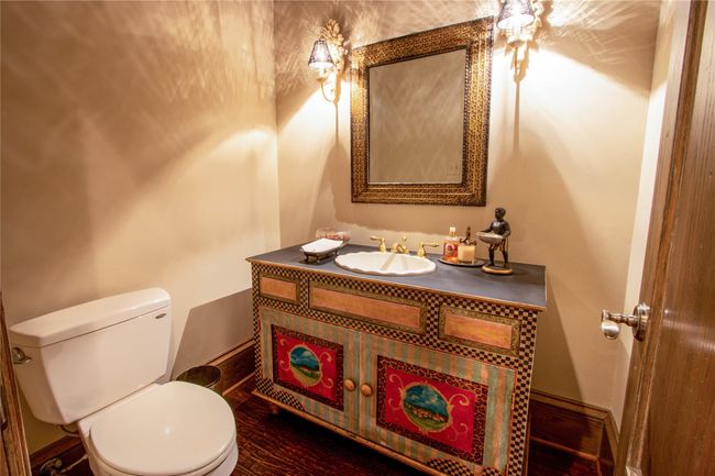 Half bathroom featuring baseboards, toilet, vanity, and a ceiling fan | Image 20