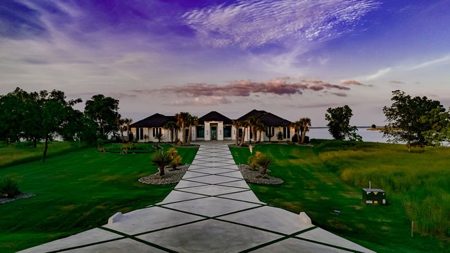 View of front of property featuring a water view, a gazebo, and a front lawn | Image 40