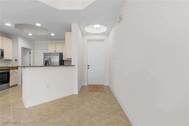 Kitchen featuring appliances with stainless steel finishes, recessed lighting, a peninsula, and light tile patterned flooring | Image 5