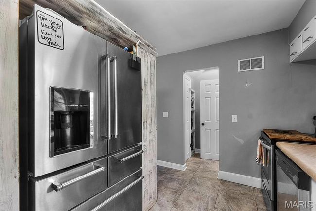 Kitchen featuring visible vents, appliances with stainless steel finishes, and baseboards | Image 11